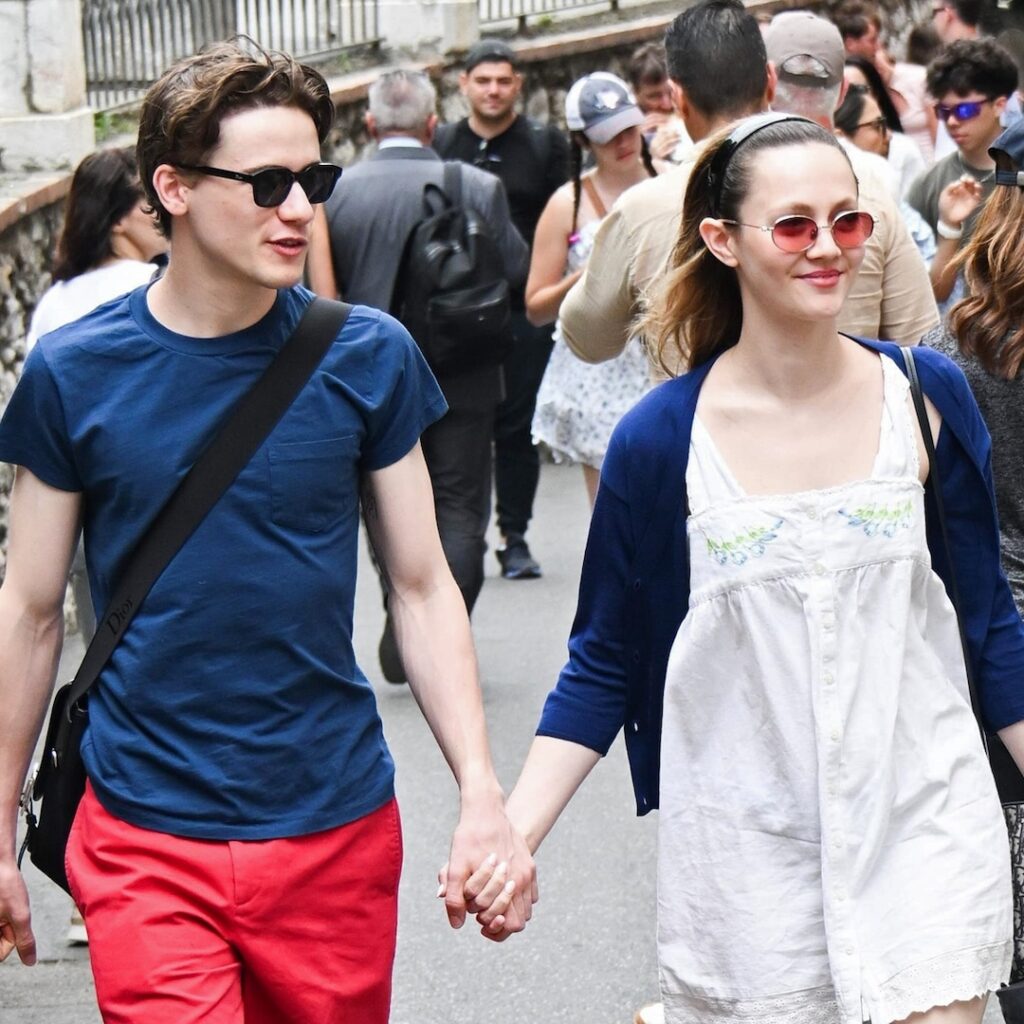 Iris Apatow and Sam Nivola holding hands in Italy